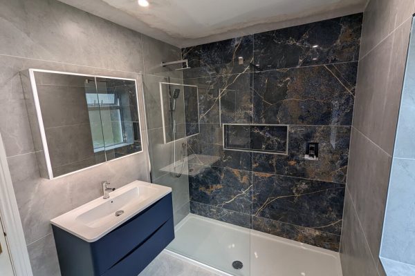 a Newtown Lane bathroom with a shower and sink