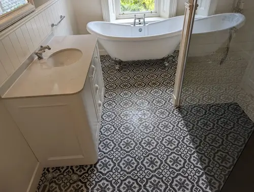 a bathroom with a flower floor tub and sink