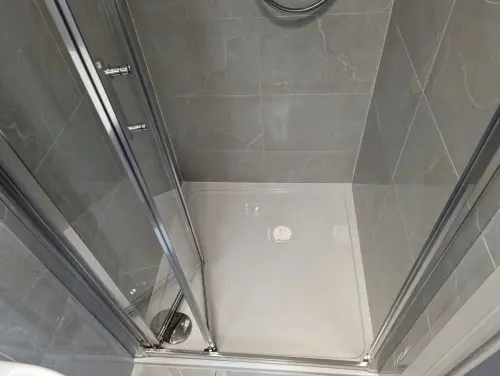 a en suite airpark shower with a glass door