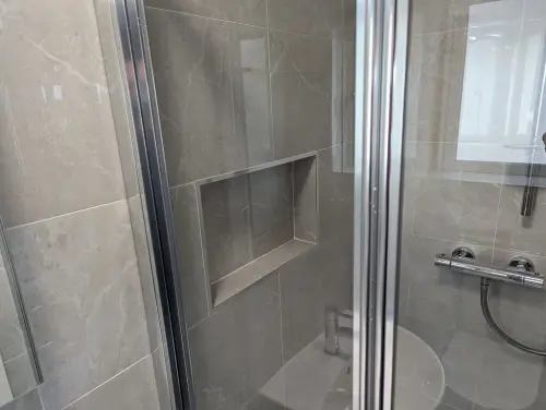a en suite shower with a glass door