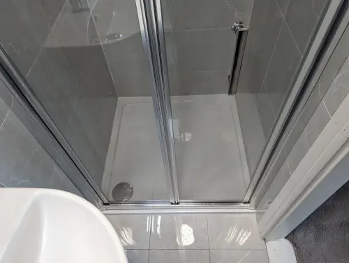 a En suite shower with a glass door