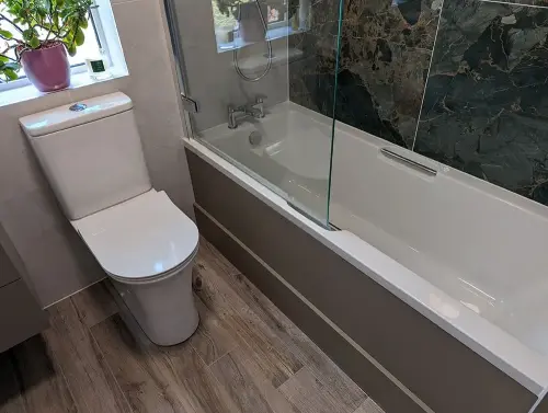 a bathroom with a tub and toilet