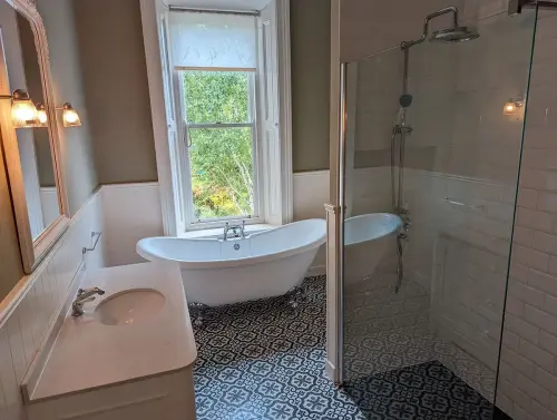 a traditional bathroom with a tub and sink